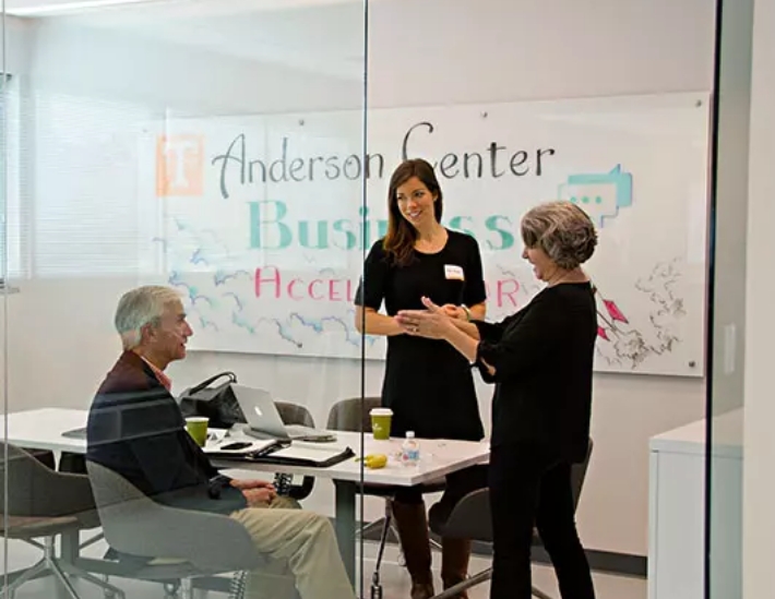 group of people talking at the anderson center