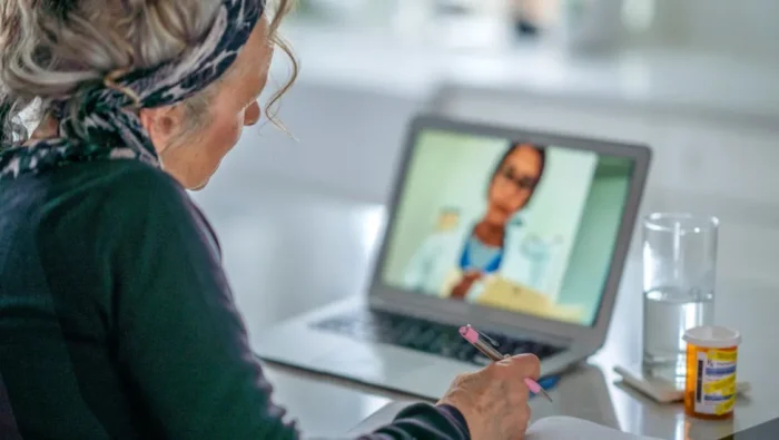 Woman consults with doctor via laptop