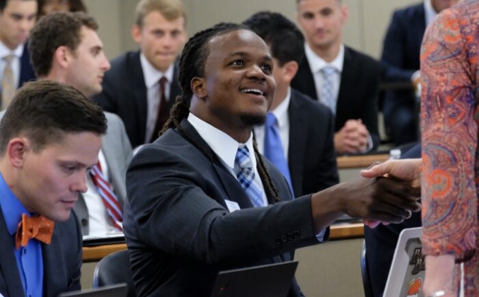 man shaking hands in class