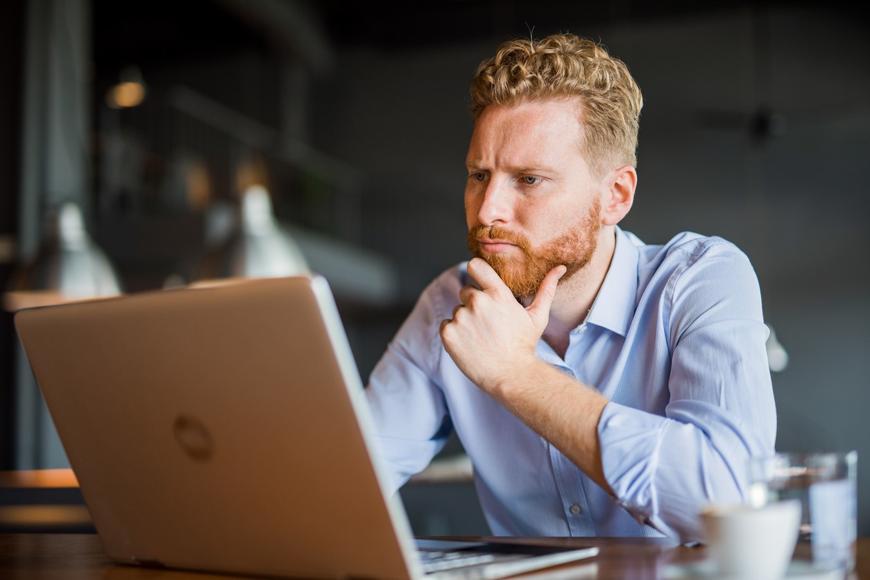 man working remotely on a laptop