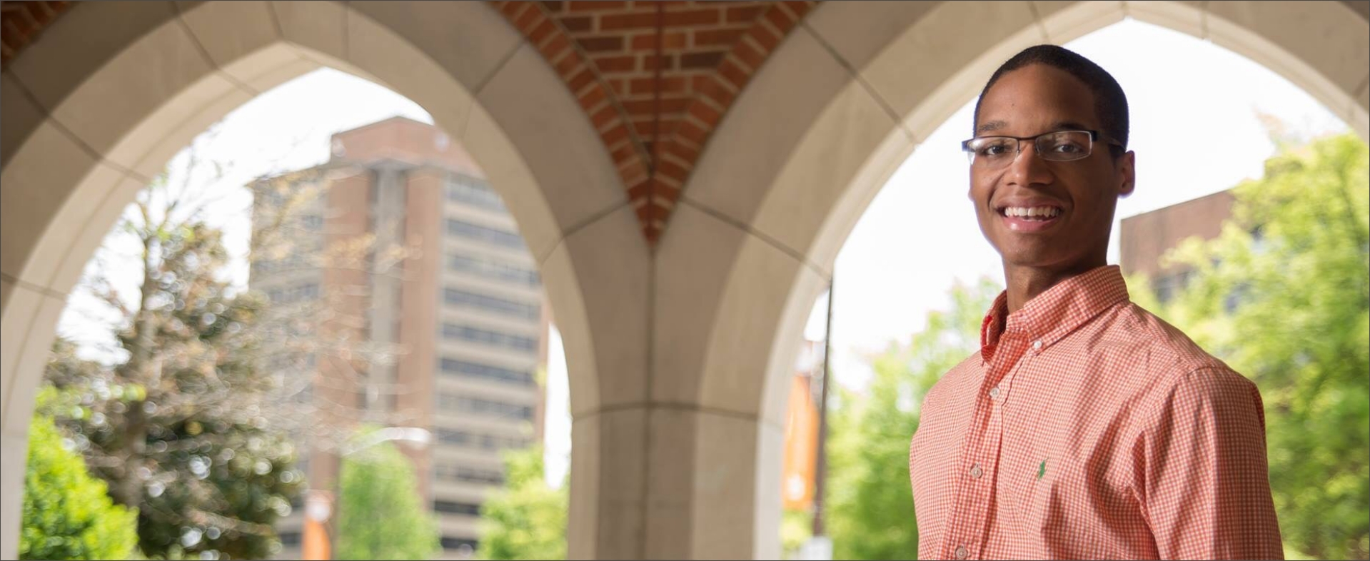 man smiling outside Haslam Business Building
