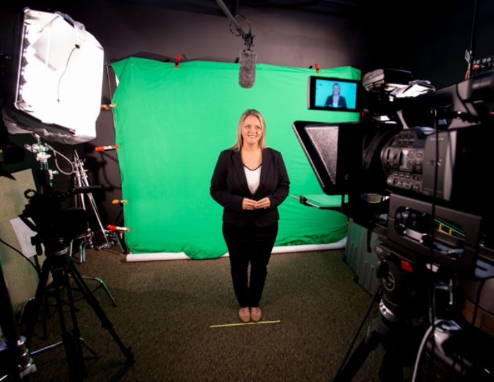 woman standing in front of studio camera