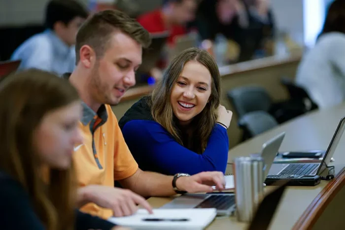 students on computer in class lecture