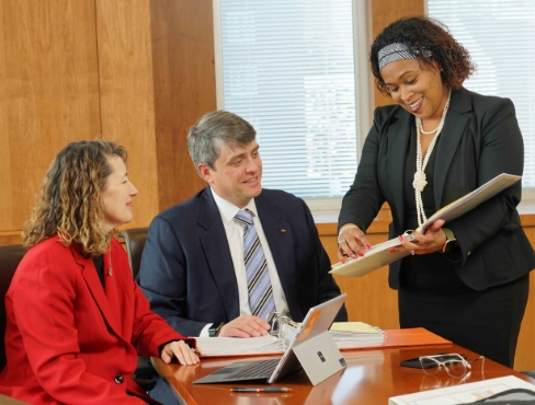 Three people in a business meeting
