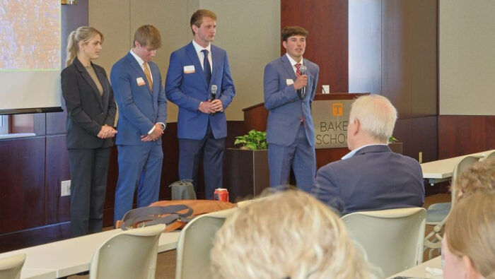 A Torch Fun team dress in business attire delivers its results to the audience.|A diverse team of professionally dressed Haslam Torch Fund student managers deliver EOY results in front of a screen at the front of a theatre-style classroom.|McClain Torch Fund team members|LaPorte Torch Fund team members||Carroll Torch Fund team members