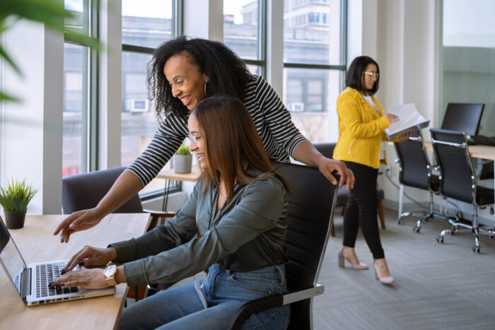 Women working together on a computer in the office