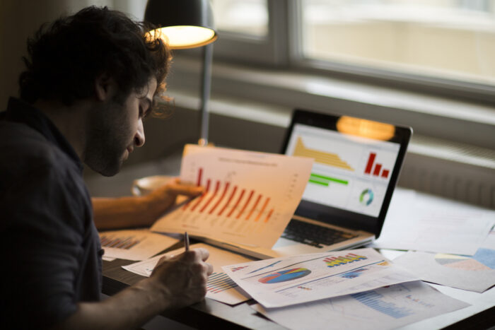 man studying statistics and charts
