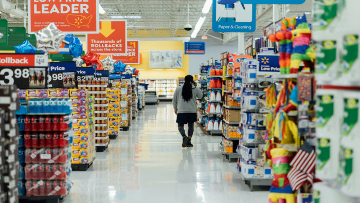 Man walks down the aisle of a grocery store||