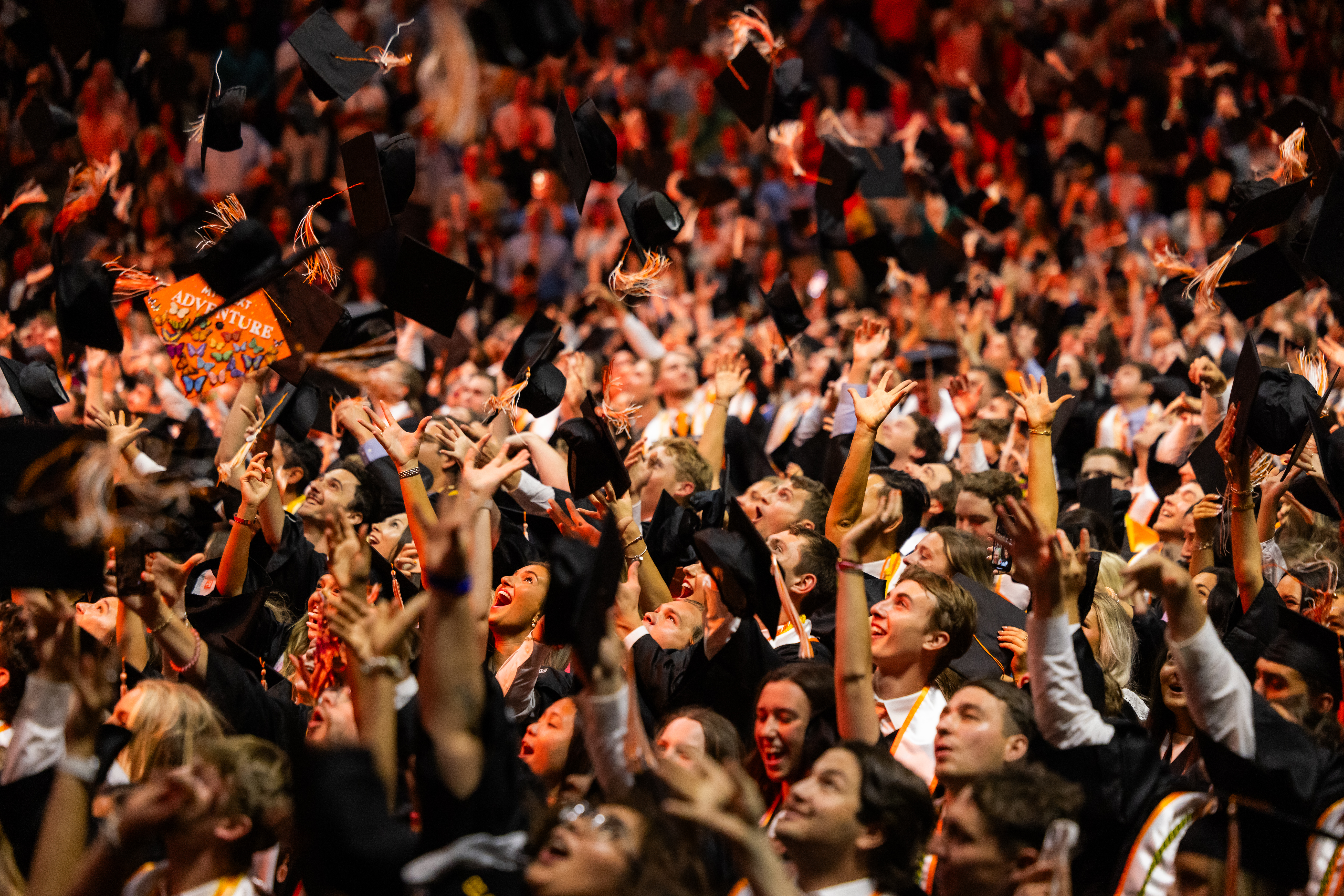 Graduates toss their caps during the Haslam commencement ceremony